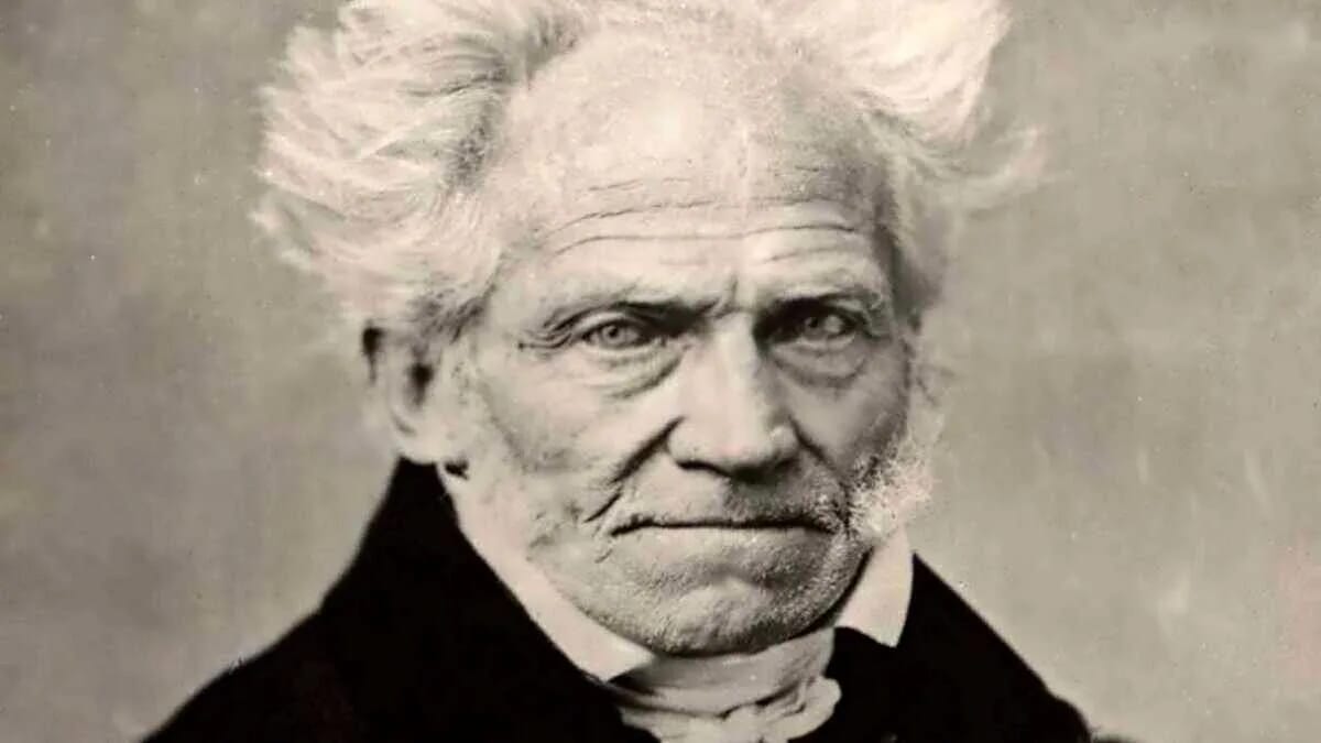 Das Schwarz-Weiß-Porträt zeigt Arthur Schopenhauer mit hellem Haar und dunkler Kleidung, passend zum Text „Woran wir öfters denken sollten“.