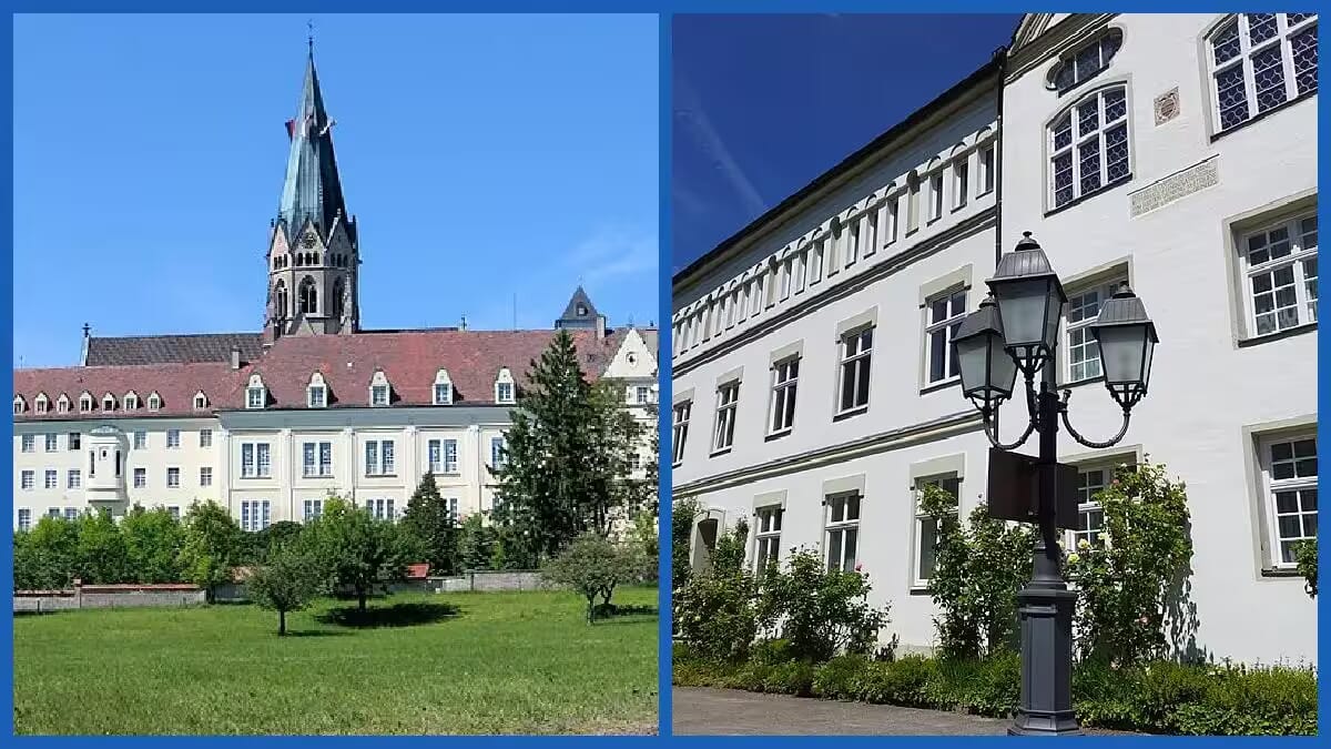 Weißes Mauerwerk und ein rot gedecktes Dach prägen St. Ottilien Kloster Abtei Gymnasium, mit Kirchturm und grünen Gartenflächen unter klarem Himmel.